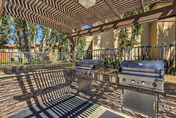 Grill area with seating on patio at Mission Grove Park luxury apartments