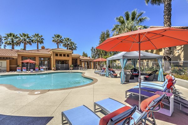 Serene outdoor pool surrounded by lush greenery at Mission Grove Park Apartments