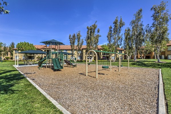 Colorful playground with slides and swings at Mission Grove Park Apartments, ideal for family-friendly fun and outdoor activities
