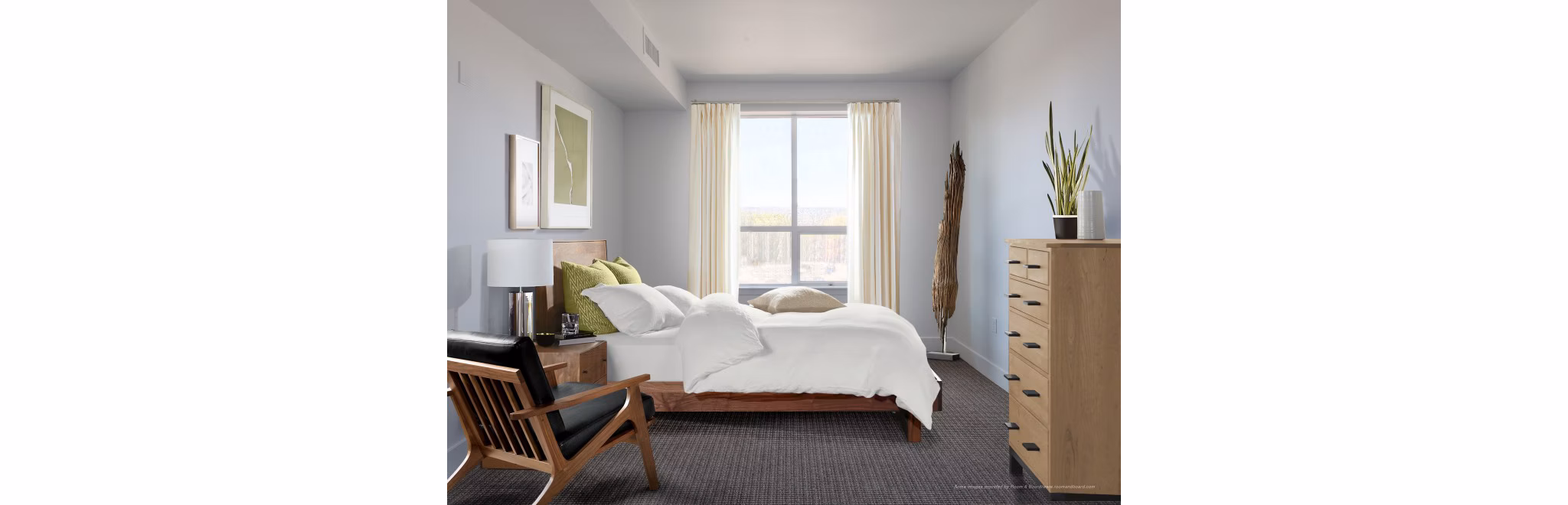 Bedroom featuring modern furnishings and natural lighting at 201 Marshall Apartments