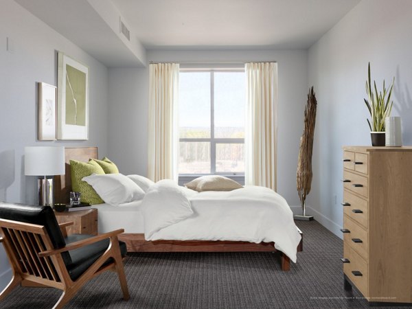 Bedroom featuring modern furnishings and natural lighting at 201 Marshall Apartments