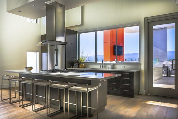 Clubhouse featuring modern lounge seating and billiards table at 201 Marshall Apartments, a Greystar luxury property