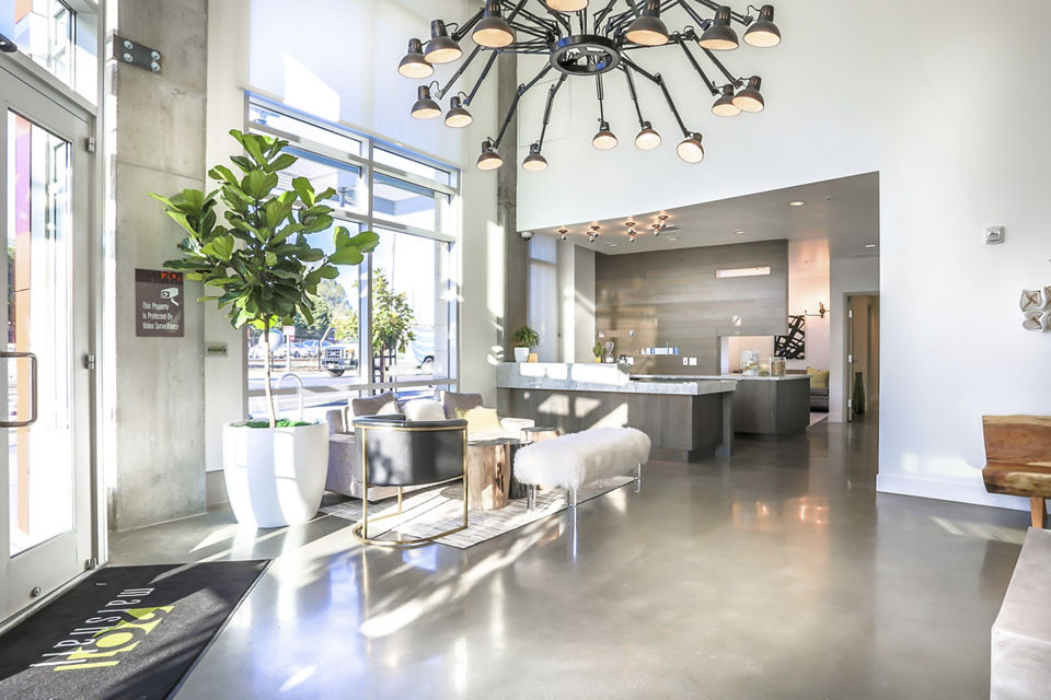 Contemporary clubhouse at 201 Marshall Apartments featuring stylish seating and a stunning fireplace