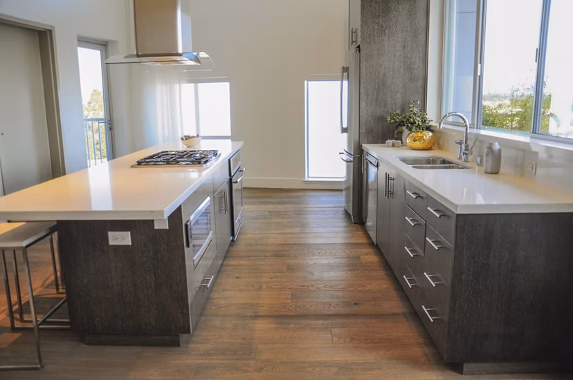 Kitchenaid stainless steel appliances and granite countertops in the modern kitchen at 201 Marshall Apartments