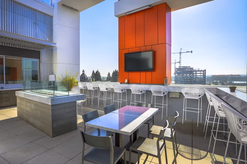 Fire pit patio with seating area at 201 Marshall Apartments, offering a cozy outdoor amenity for residents