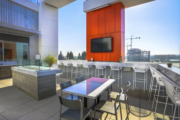 Fire pit patio with seating area at 201 Marshall Apartments, offering a cozy outdoor amenity for residents