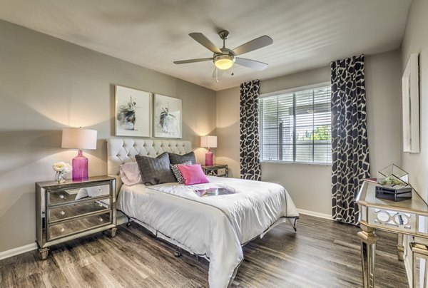 Inviting bedroom with cozy decor and large windows at Signature Point Apartments