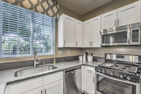 Spacious kitchen with modern appliances at Signature Point Apartments, offering luxury living spaces for residents