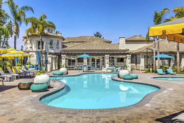 Resort-style pool with lounge chairs at Signature Point Apartments, perfect for relaxation and leisure