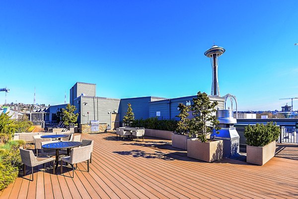 Luxury outdoor patio space at Axis Apartments with modern seating and lush greenery, perfect for relaxation and leisure in the heart of urban living