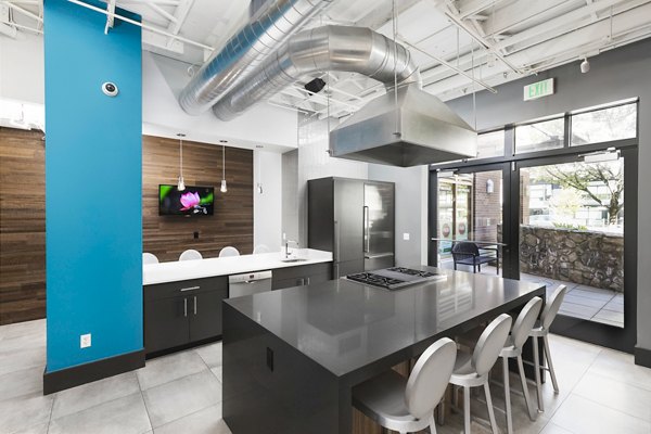 Modern clubhouse with community seating and workspaces at Dexter Lake Union Apartments, featuring luxury amenities in a vibrant Seattle location