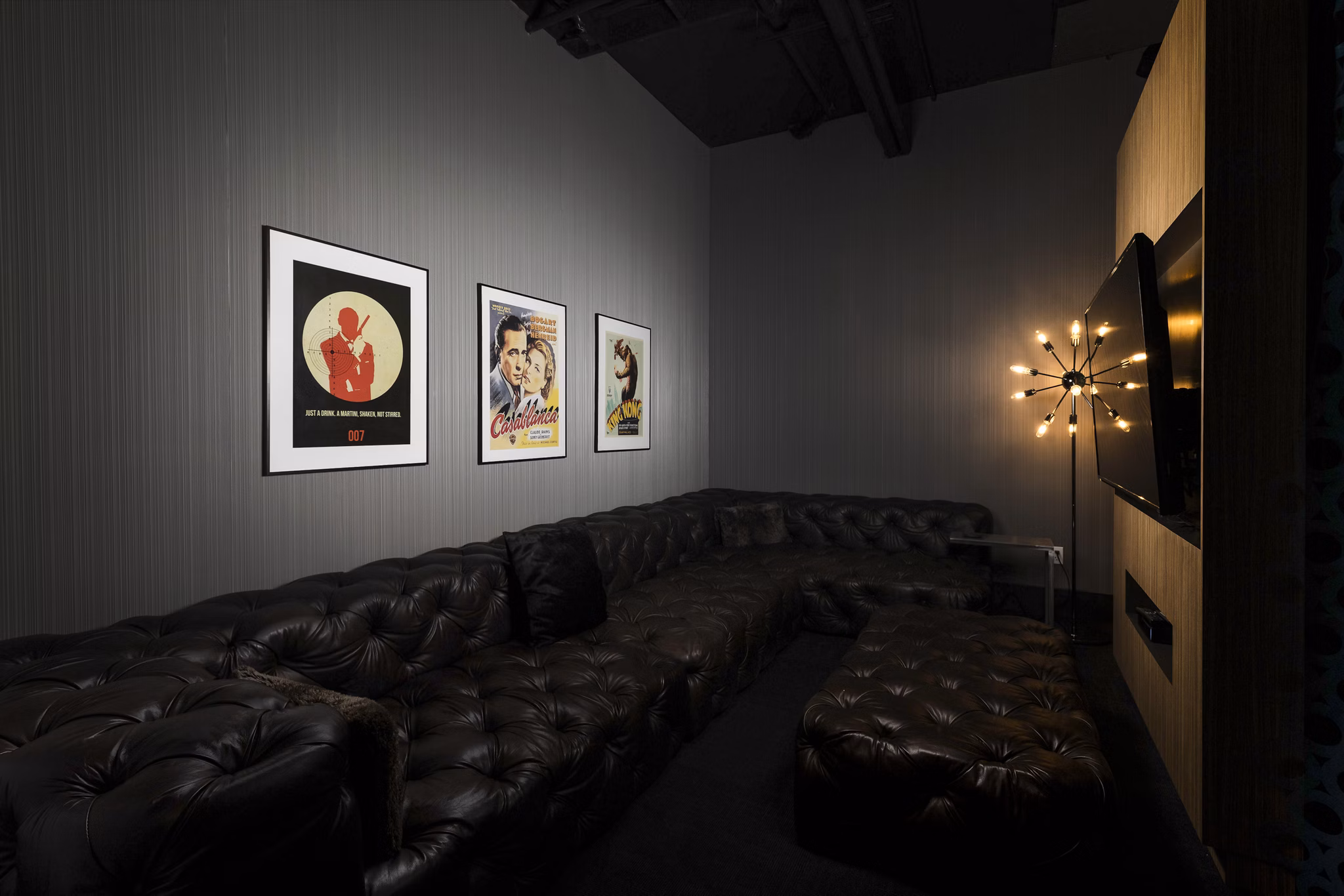 Screening room with plush seating at Dexter Lake Union Apartments for entertaining