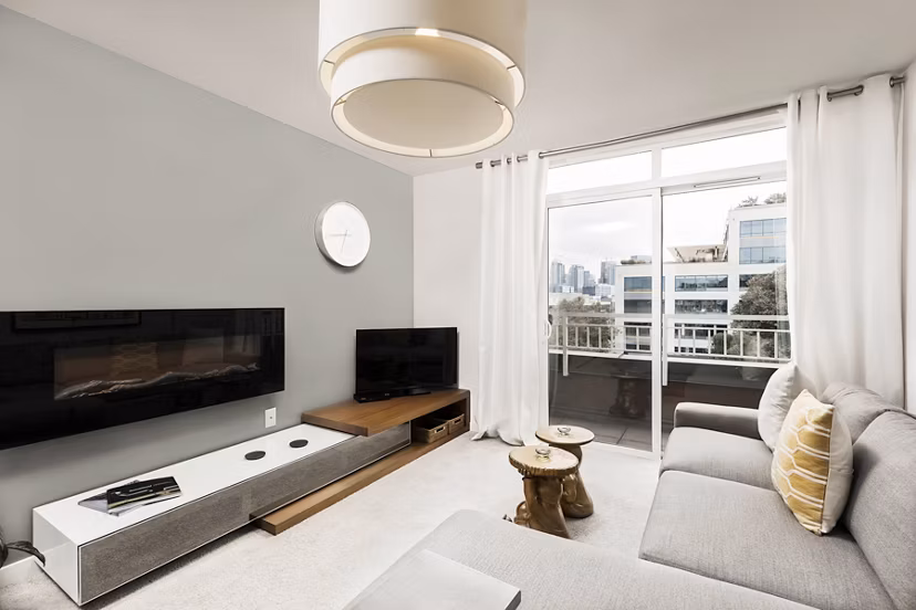Spacious living room with modern furnishings and large windows at Dexter Lake Union Apartments