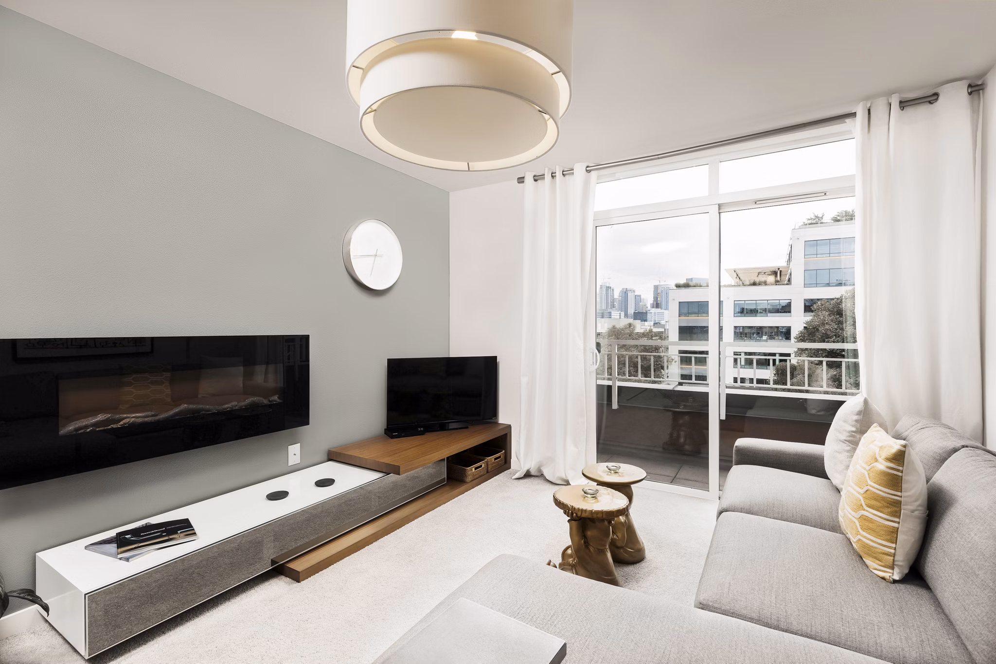 Spacious living room with modern furnishings and large windows at Dexter Lake Union Apartments