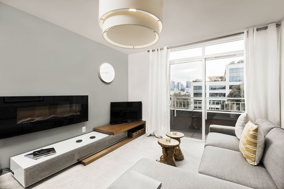 Spacious living room with modern furnishings and large windows at Dexter Lake Union Apartments