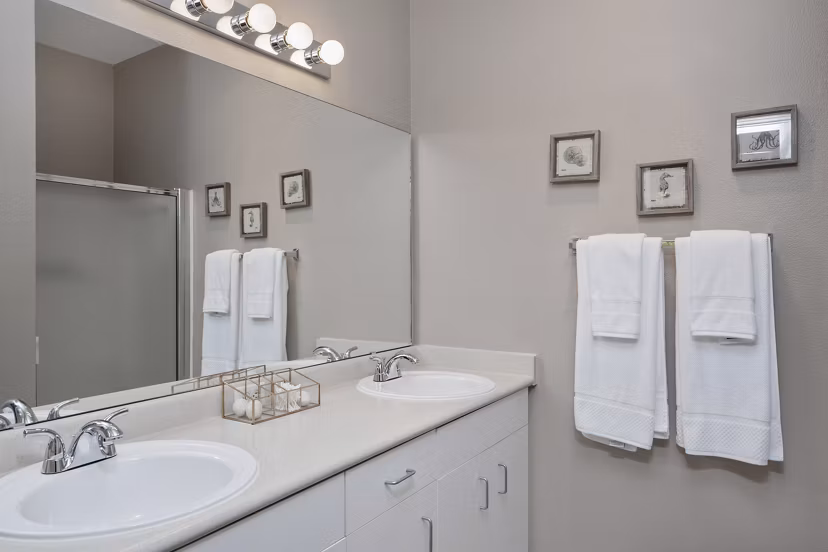Lions Gate South Apartments: Modern bathroom with sleek fixtures and marble countertops