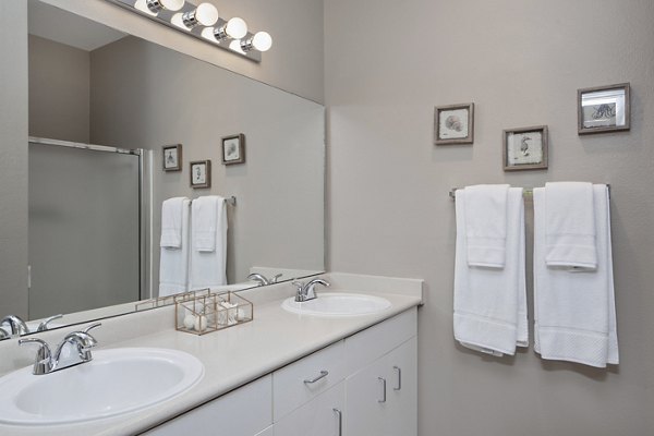 Lions Gate South Apartments: Modern bathroom with sleek fixtures and marble countertops