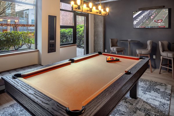 Game room with pool tables and lounge at The Wyatt Apartments, offering entertainment and relaxation for residents