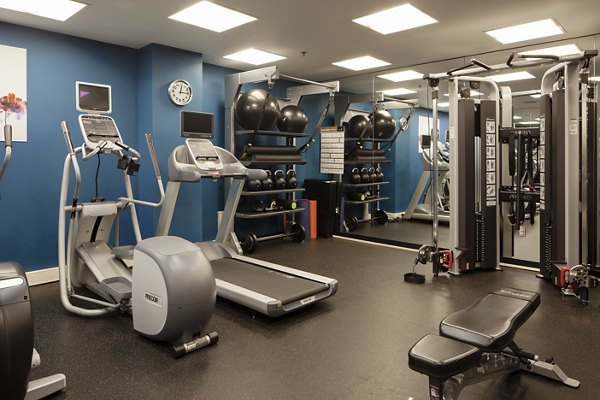 Fully-equipped fitness center featuring modern cardio machines at The Wyatt Apartments