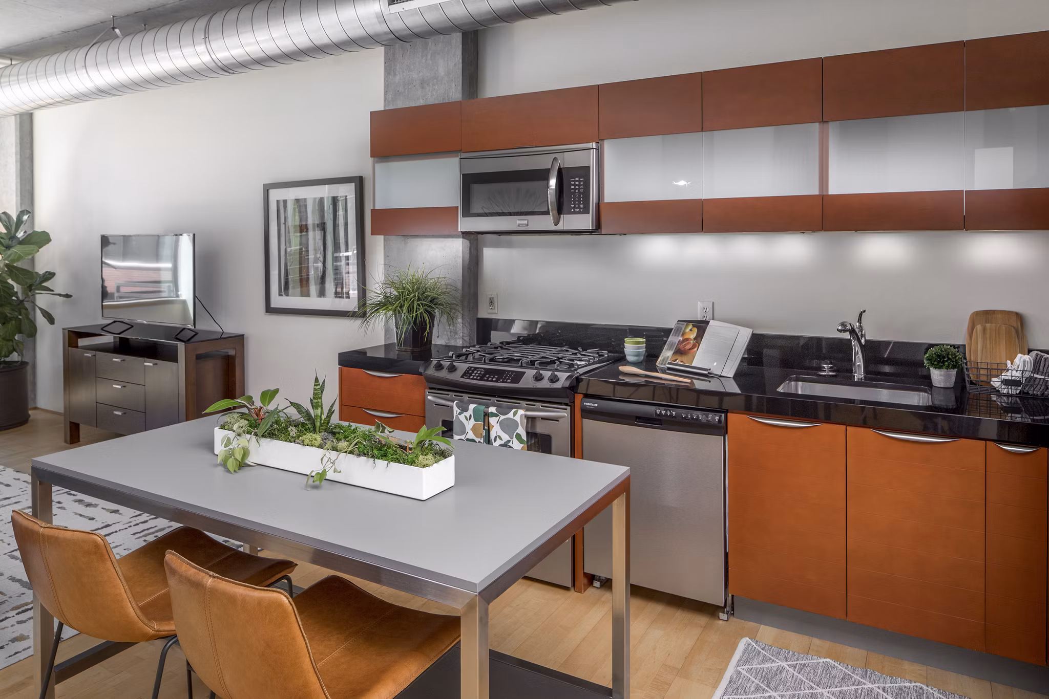 Modern kitchen with stainless steel appliances in The Wyatt Apartments