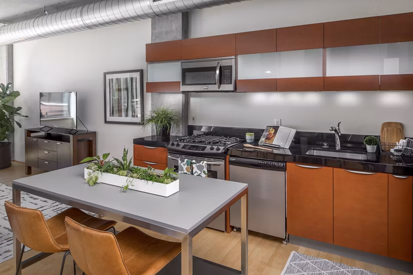 Modern kitchen with stainless steel appliances in The Wyatt Apartments