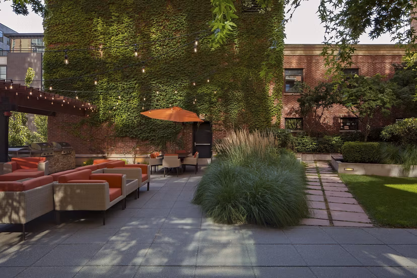 Tranquil courtyard with lush landscaping at The Wyatt Apartments, offering a serene outdoor retreat in a luxury living environment