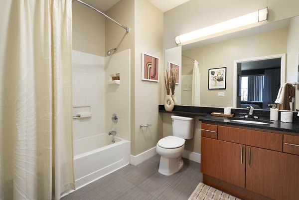 Modern bathroom with elegant fixtures and ample lighting at Bridgepointe Apartments luxury residences