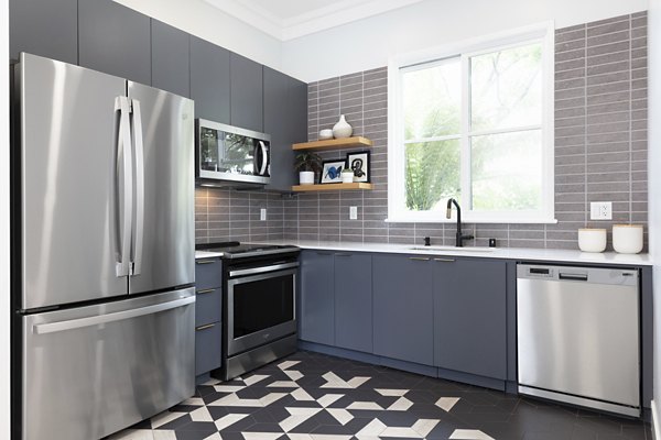 Modern kitchen with granite countertops and stainless steel appliances at Bridgepointe Apartments