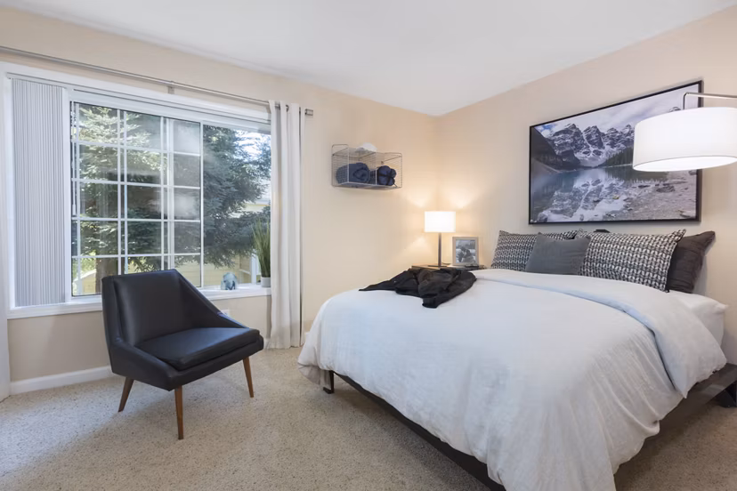Bedroom with modern furnishings at Central Park at Whisman Station Apartments Cozy ambience and stylish decor create a relaxing retreat