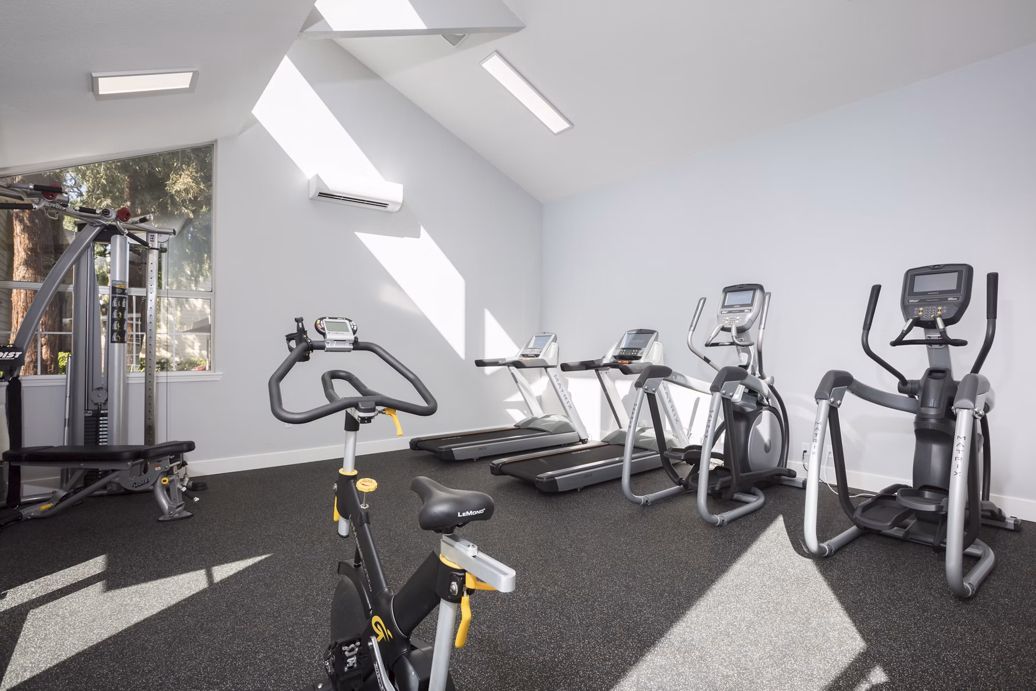 State-of-the-art fitness center at Central Park at Whisman Station Apartments with modern equipment and spacious workout areas