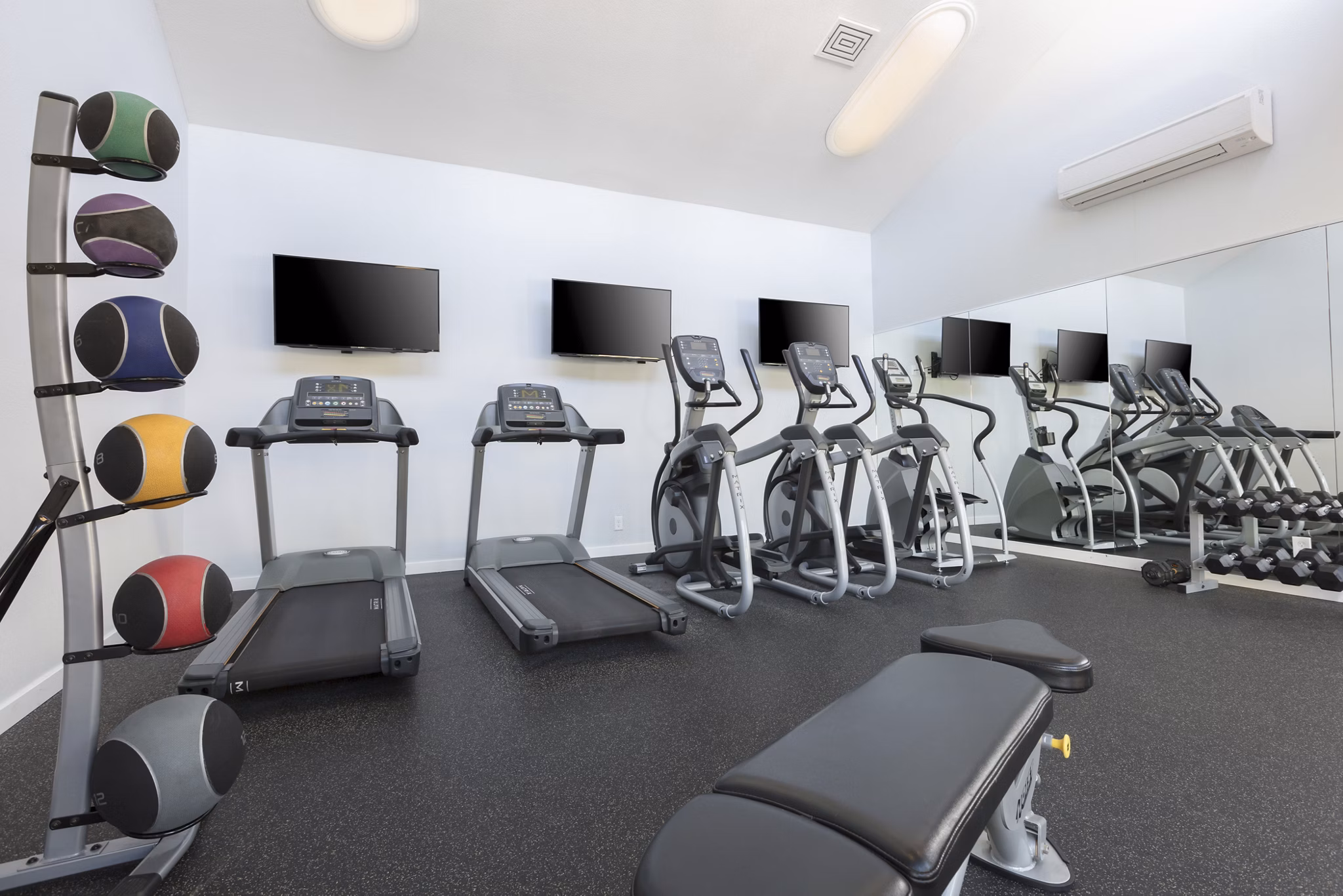 State-of-the-art fitness center at Central Park at Whisman Station Apartments with modern equipment and spacious workout areas
