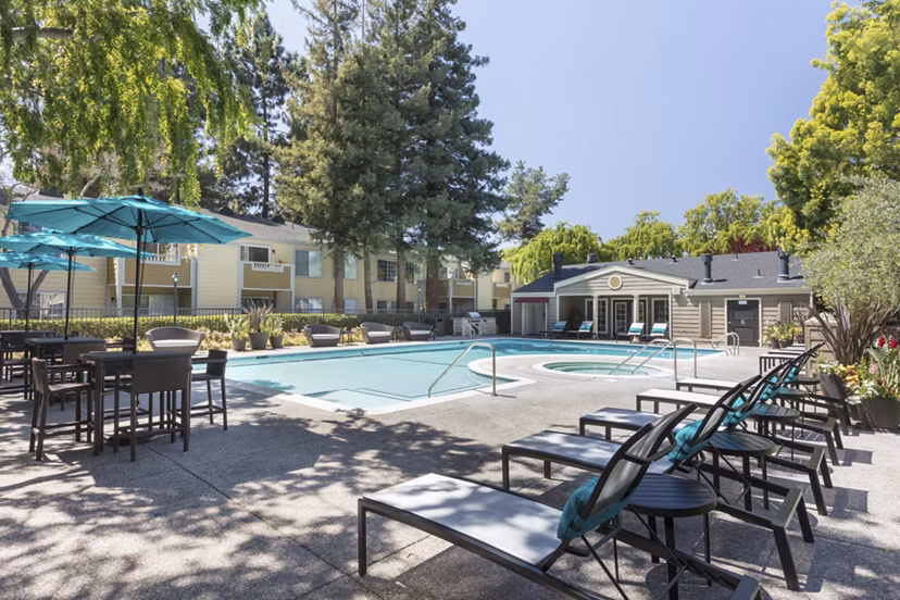 Resort-style pool at Central Park at Whisman Station Apartments with lounge chairs and landscaped surroundings