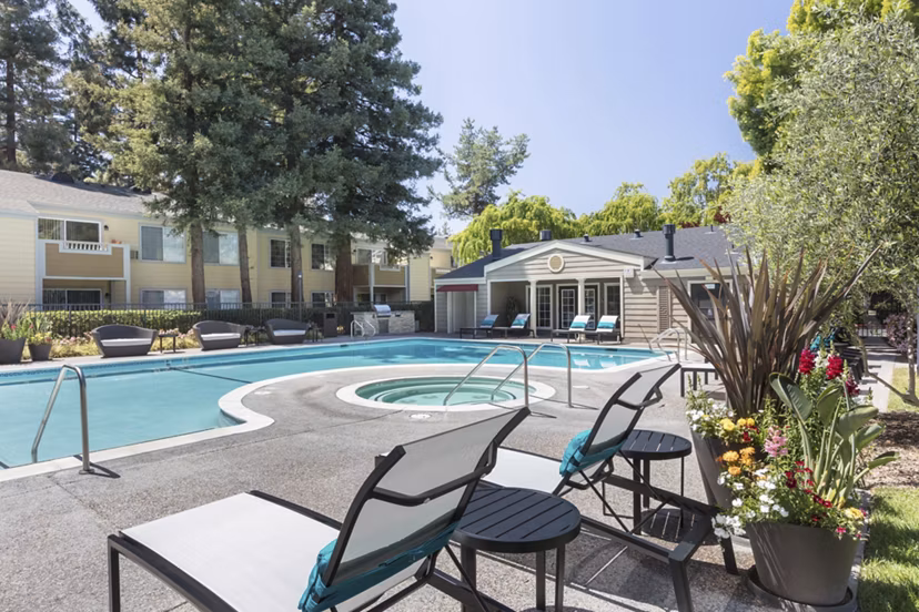 Relaxing pool area with lounge chairs at Central Park at Whisman Station Apartments