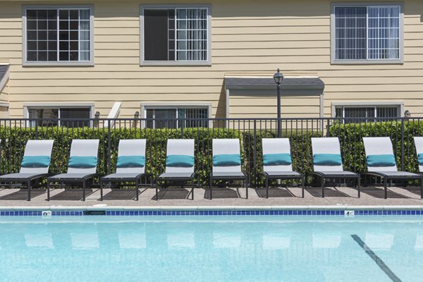 Inviting pool area at Central Park at Whisman Station Apartments with lounge chairs and lush greenery
