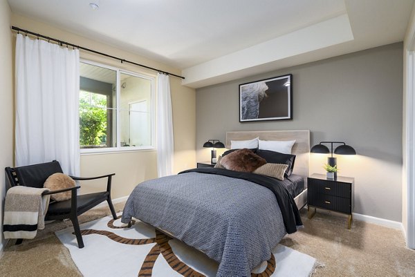 Cozy bedroom with stylish decor at Domicilio Apartments, a luxury Greystar community