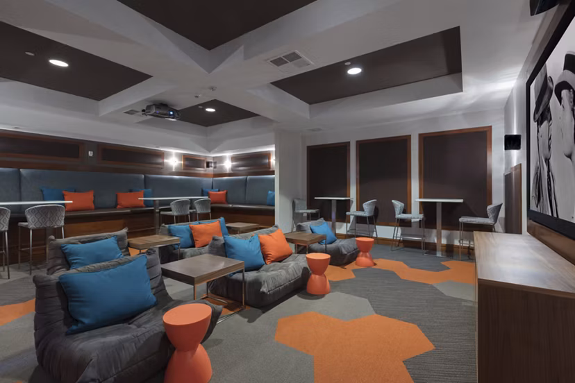 Domicilio Apartments: Modern theater room featuring plush seating and large screen for entertainment in Santa Clara