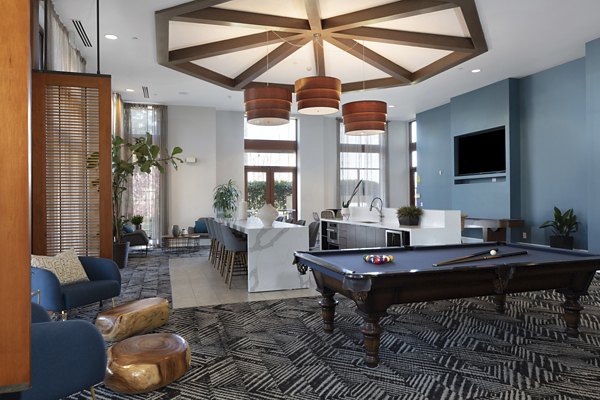Domicilio Apartments: Elegant clubhouse with modern design and comfortable seating