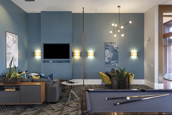 Clubhouse offering modern design and lounge seating at Domicilio Apartments, a Greystar luxury community