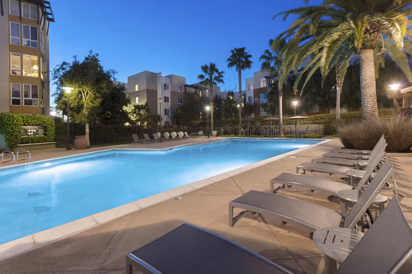 Domicilio Apartments: Resort-style pool with lounge chairs for luxury living in Santa Clara, perfect for relaxation and social gatherings