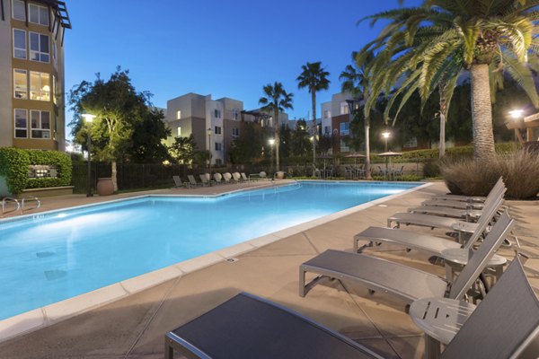 Domicilio Apartments: Resort-style pool with lounge chairs for luxury living in Santa Clara, perfect for relaxation and social gatherings