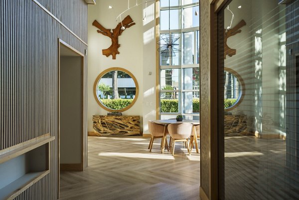 Modern clubhouse with stylish seating and fireplace at Elements Apartments