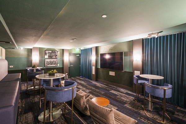 Elements Apartments: Modern theater room with comfortable seating and state-of-the-art screen for residents' entertainment