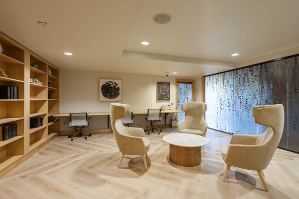 Modern business center with workstations and conference room at Elements Apartments