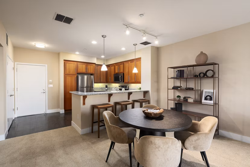 Dining area featuring modern furniture and natural light at Elements Apartments