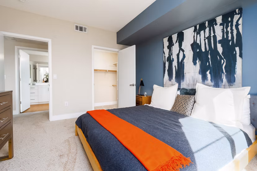 Luxurious bedroom with modern decor and ample natural light at Mosaic Apartments in the Greystar community