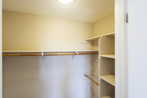 King-sized bed with modern decor and ample natural light in Mosaic Apartments bedroom