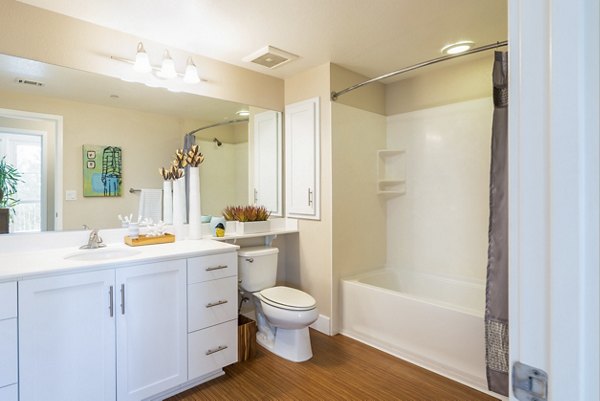 Modern bathroom featuring sleek fixtures and ample lighting at Mosaic Apartments, luxury living by Greystar