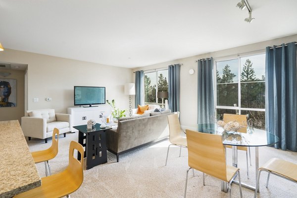 Modern living room with stylish decor and natural light at Mosaic Apartments