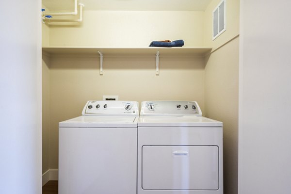 Laundry room with modern appliances in Mosaic Apartments, a Greystar luxury community