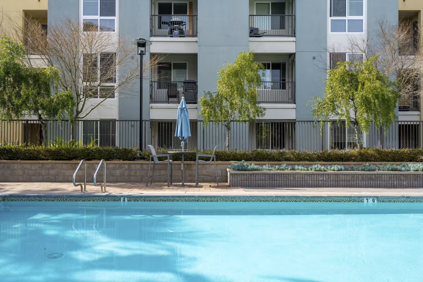 Resort-style pool with loungers at Mosaic Apartments, luxury living in prime urban location